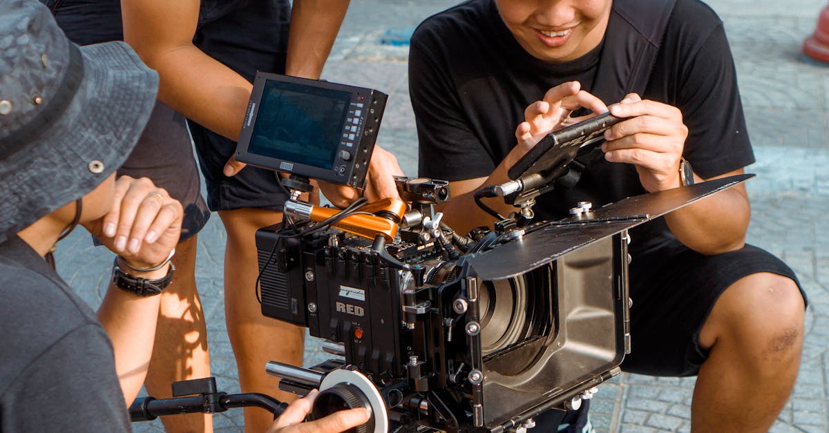 Filmmakers adjusting camera equipment on set outdoors, showcasing collaborative effort.